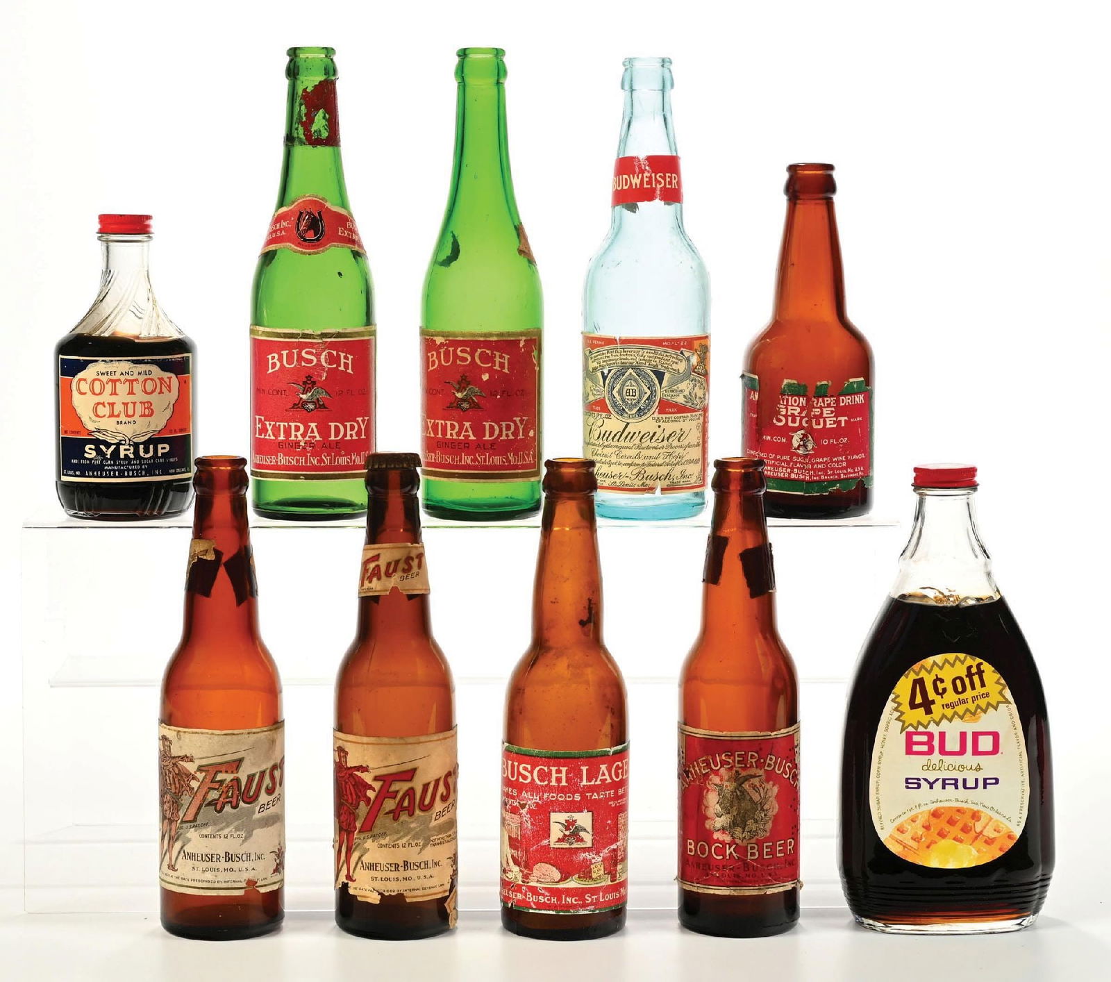 COLLECTION OF 10: ANHEUSER-BUSCH BUDWEISER BOTTLES: Miscellaneous bottles featuring beer and Anheuser-Busch syrups. CONDITION: Nice examples. All have some light to moderate wear. Condition: (6.0 - 8.5). Dimensions: Largest: 9 - 1/2" T.