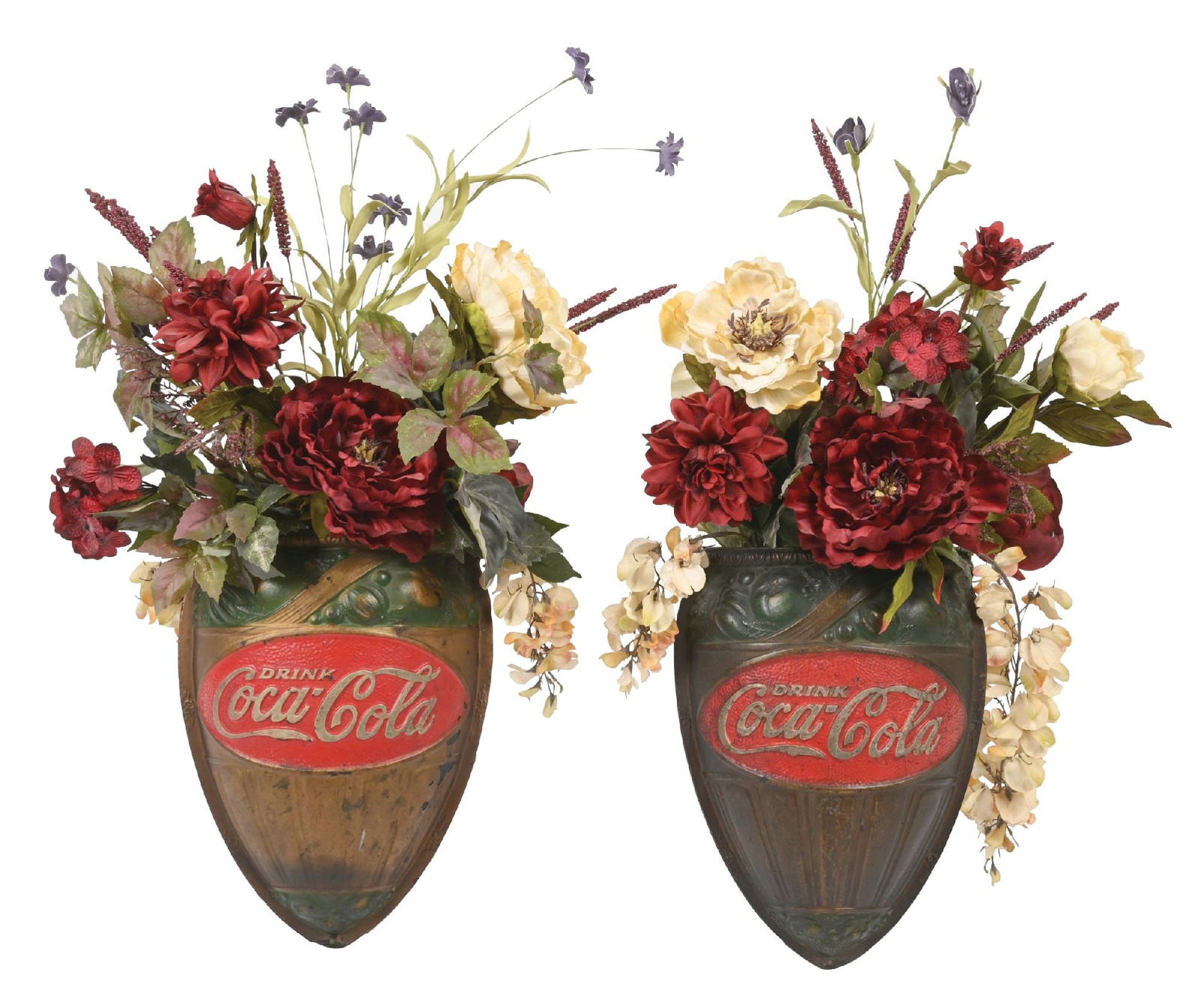 COLLECTION OF 2 COCA-COLA WALL SCONCES WITH FLOWERS: A nice collection of two c. 1930s paper mache wall sconces from Coca-Cola featuring the iconic company logo. These sconces come with nice floral arrangements. CONDITION: Both sconces show light areas