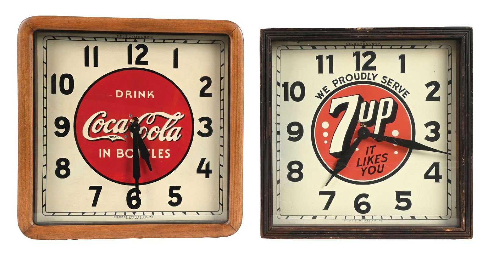 A PAIR OF ADVERTISIMG SDOFT DRINK CLOCKS, 7UP AND DRINK COCA-COLA: CONDITION: (A) A Selected Devices Coca-Cola Tin front clock. Showing light overall wear. Some surface scratches top the wood frame, surface scratch to the left of the Drink wording and light scuffs