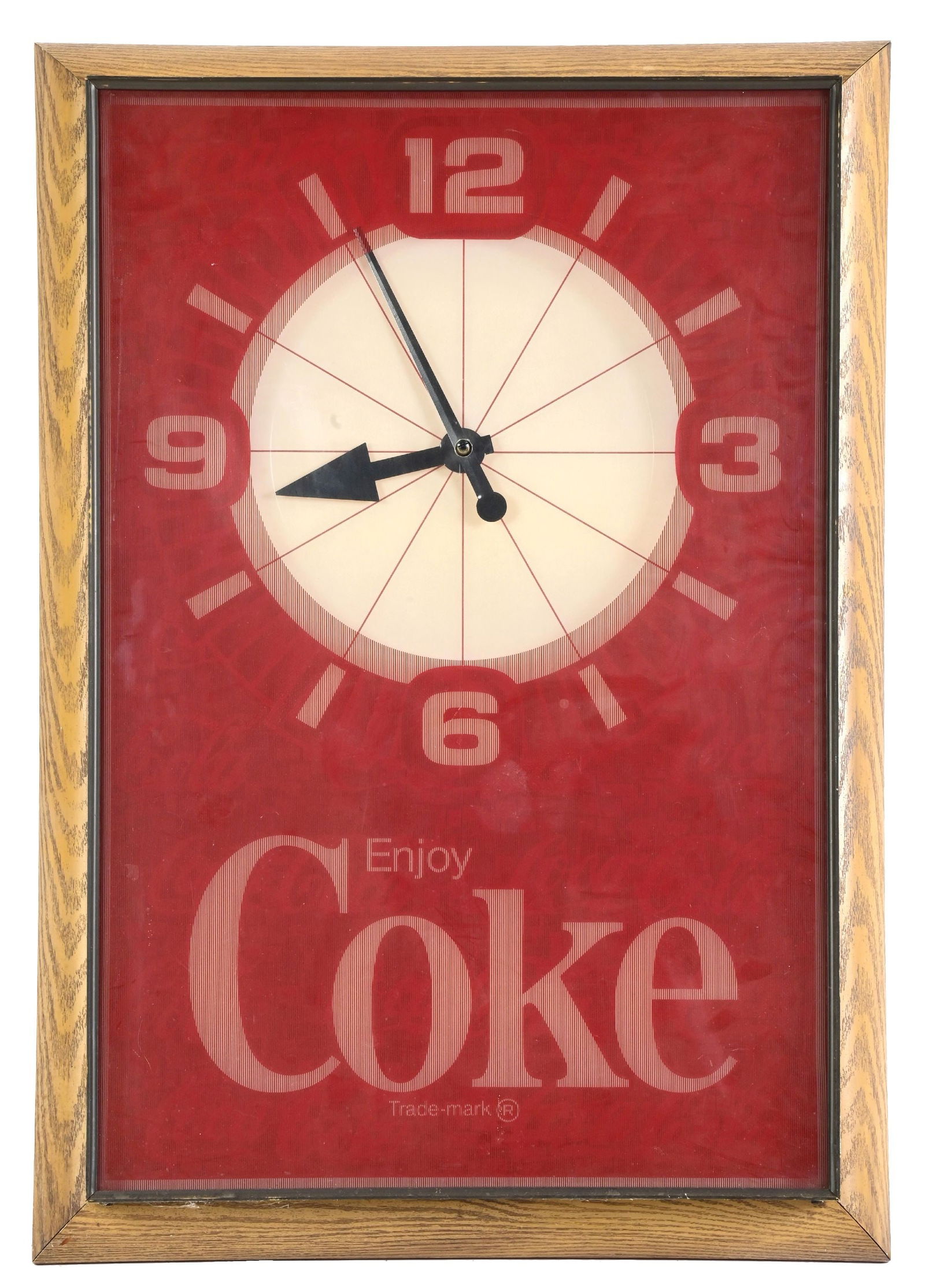 COCA-COLA ELECTRIC WALL CLOCK: Made by the Indoor Electric Sign Co. CONDITION: Showing a plastic front with original Coca-Cola lighted backdrop, original hands with faux-wood frame. Original cord. Lighted. Shows light surface scrat