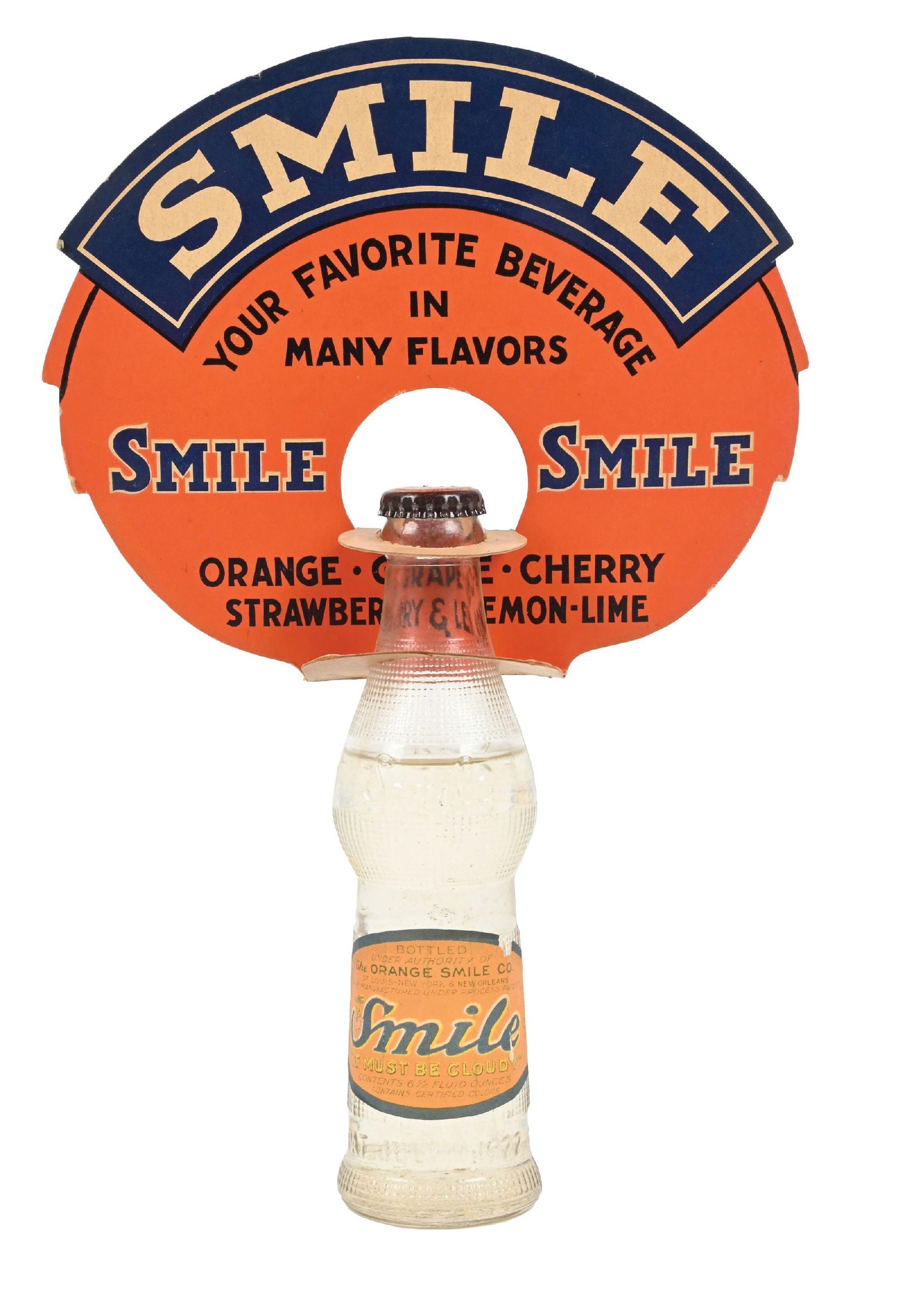 SMILE ORANGE SOFT DRINK BOTTLE W/ ORIGINAL TOPPER: CONDITION: Cardstock topper is single-sided, showing good color with light edge wear. The Smile Soft Drink bottle comes with an original paper label, with one area of missing paper in the upper