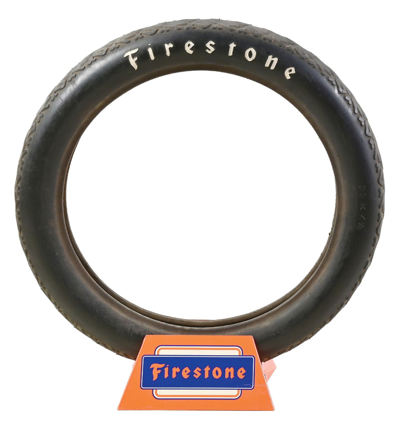 FIRESTONE TIRE TIN DISPLAY STAND WITH ORIGINAL FIRESTONE TIRE.: Double Sided Tin Service Station Tire Display for Firestone Tires showing original Firestone Tire. CONDITION: Stand is bright & glossy throughout each side showing light areas of surface scratching a