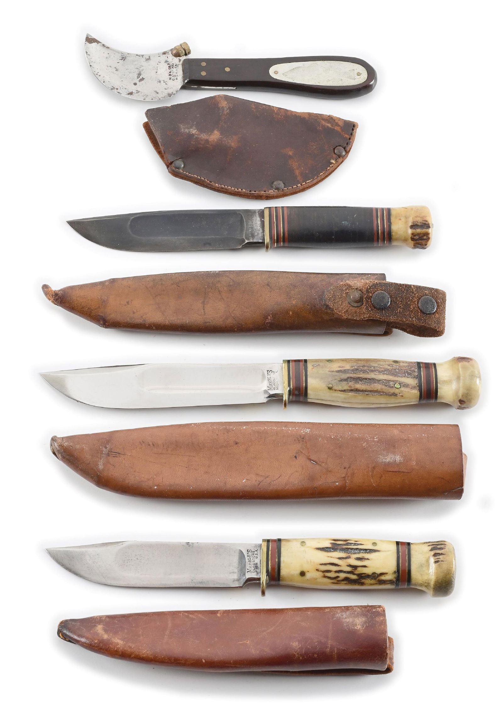 LOT OF 4: MARBLE’S AND MSA SHEATH KNIVES, FISH KNIFE, STAG CANOES, AND IDEAL STAG WITH TUBE: Lot consists of: (A) Appears lightly used and lightly sharpened. “MSA CO. GLASTONE, MICH. USA” stamped on blade obverse. Nickel silver fish shield on the obverse ebony handle. Original lea