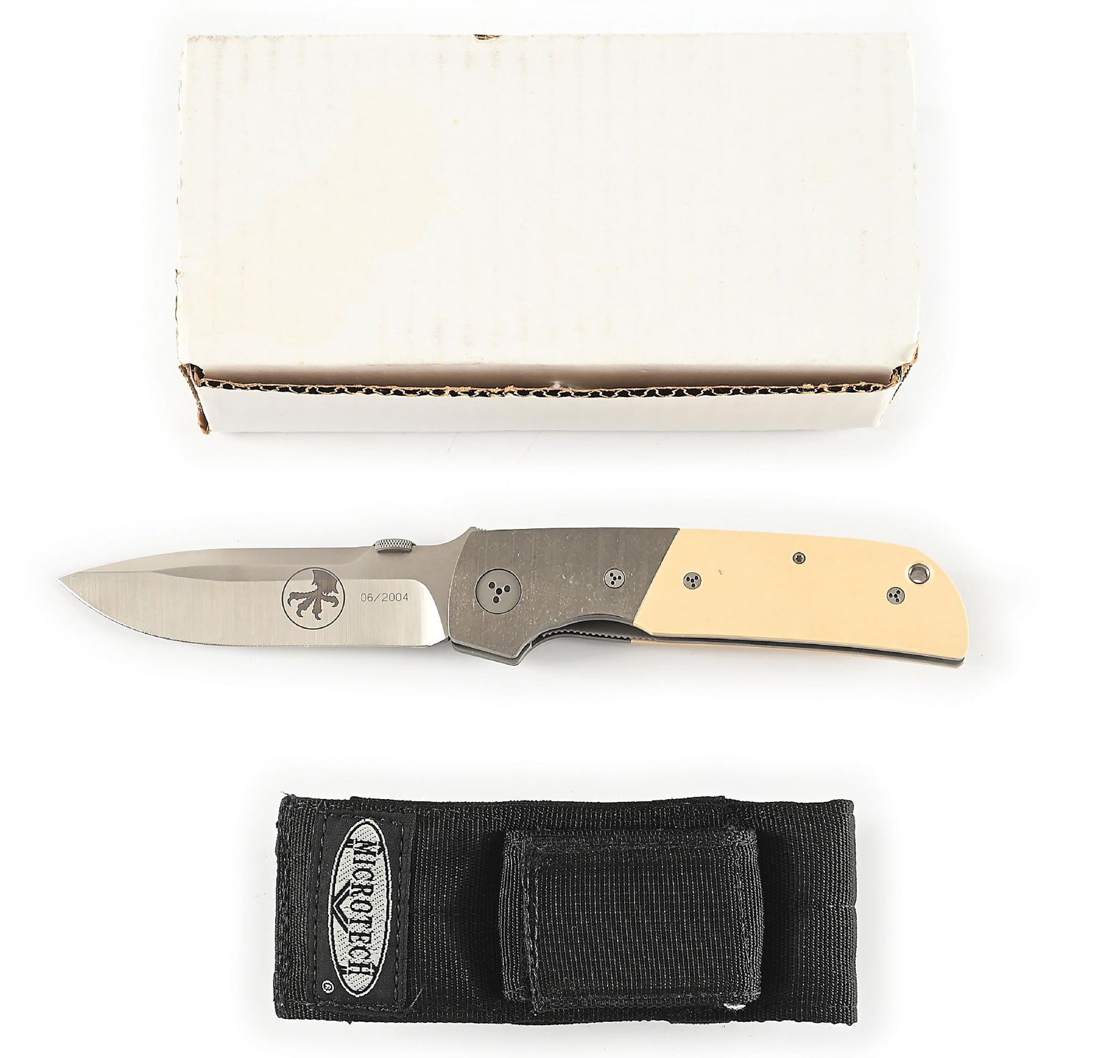 RARE. MICROTECH 08/2003 A. MARFIONE, R. TERZUOLA BOLSTER RELEASE DOUBLE ACTION DAGGER LOGO: Appears unused and unsharpened. Satin plain blade is hand ground by Anothony Marfione and is marked with the Microtech eagle claw logo on obverse. Numbered "06/2024". Thumb stud for manual opening. Bo