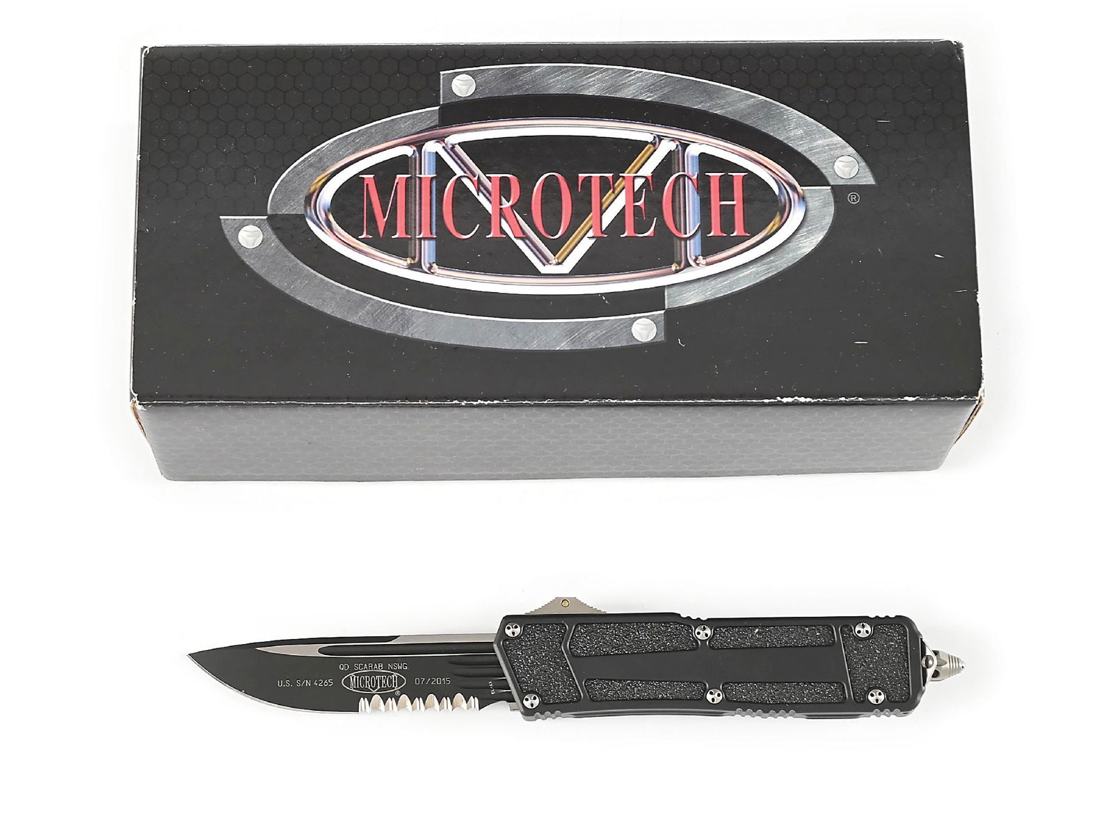 BOXED MICROTECH 182-2 NAVY SCARAB.: Microtech 182-2 Navy Scarab that features a satin and black partially serrated blade marked "QD SCARAB NSWG" with Microtech logo. Numbered "U.S. S/N 4265" and dated "07/2015". Black aluminum handle wi