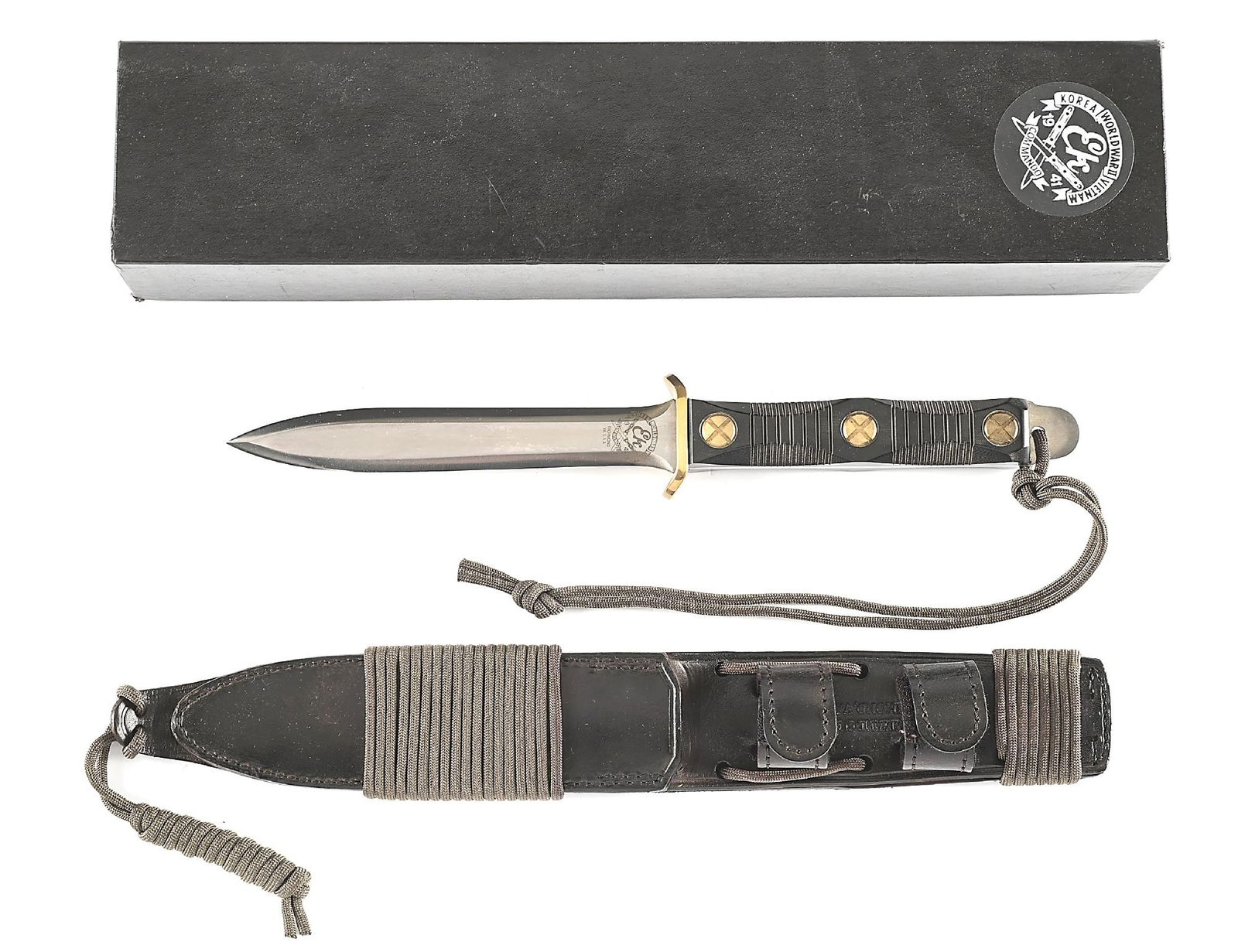 JOHN EK M-4 COMMANDO KNIFE.: A John Ek M-4 Commando knife that was ordered by a US Army Sergeant. The knife features a satin finished dagger blade marked with the Ek Commando Knife Company logo on the obverse ricasso. Small brass