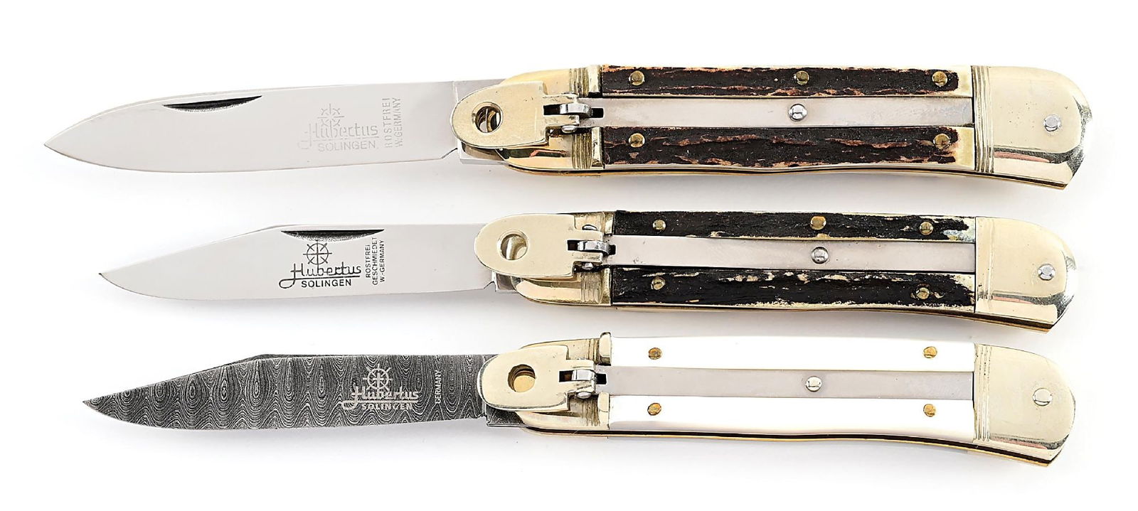 LOT OF 3: C.1960S-90S HUBERTUS SOLINGEN STAG AND MOTHER OF PEARL HANDLE DAMASCUS LEVER LOCK: Lot consists of: (A) Appears unused and unsharpened. Marked “W. Germany”. Blade is fully etched on obverse. Works fine. Locks open firmly. Nickel silver bolsters and brass liners. Stag