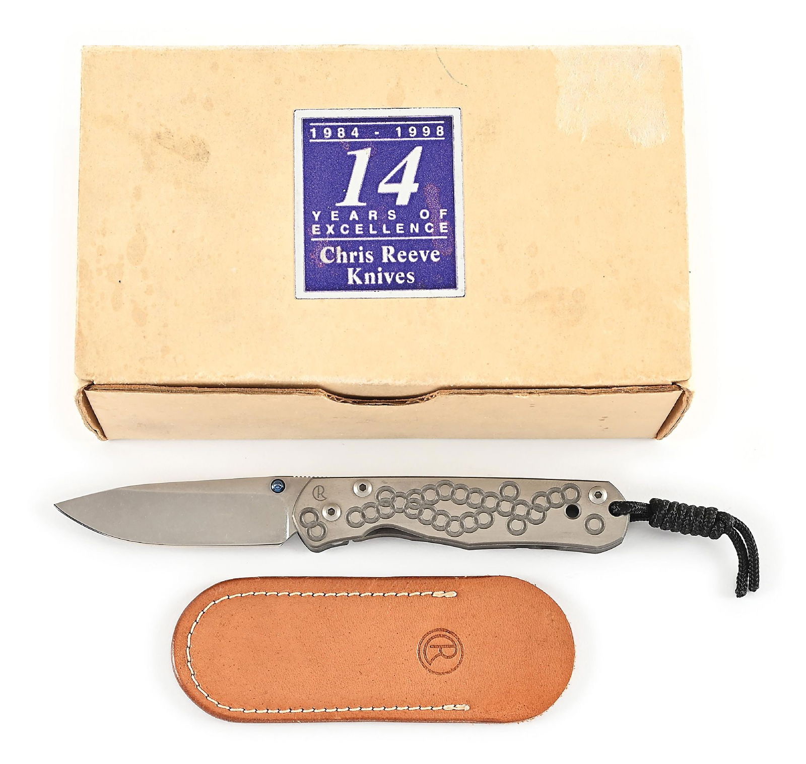 BOXED CHRIS REEVE UMFAAN.: Features a tumble finished BG42 blade with anodized titanium thumb studs and knurled thumb rest. Titanium frame is marked near the pivot screw on obverse with the “CR” logo. Obverse side i