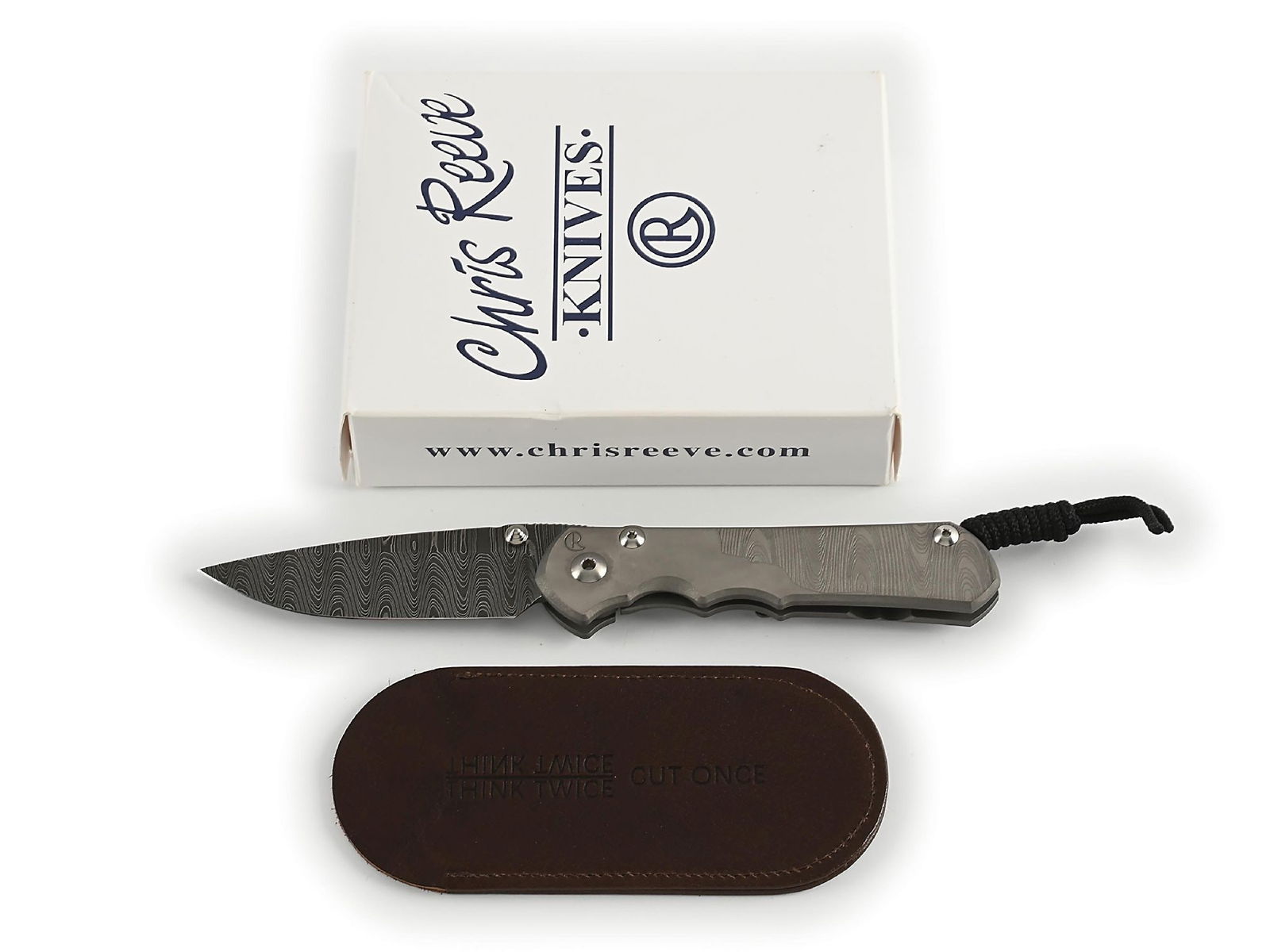BOXED CHRIS REEVE LADDER DAMASCUS SEBENZA.: Features a Devin Thomas stainless "Ladder" Damascus blade with dual thumb stud and knurled thumb rest. Titanium frame is marked near the pivot screw on obverse with the “CR” logo and "IDAH