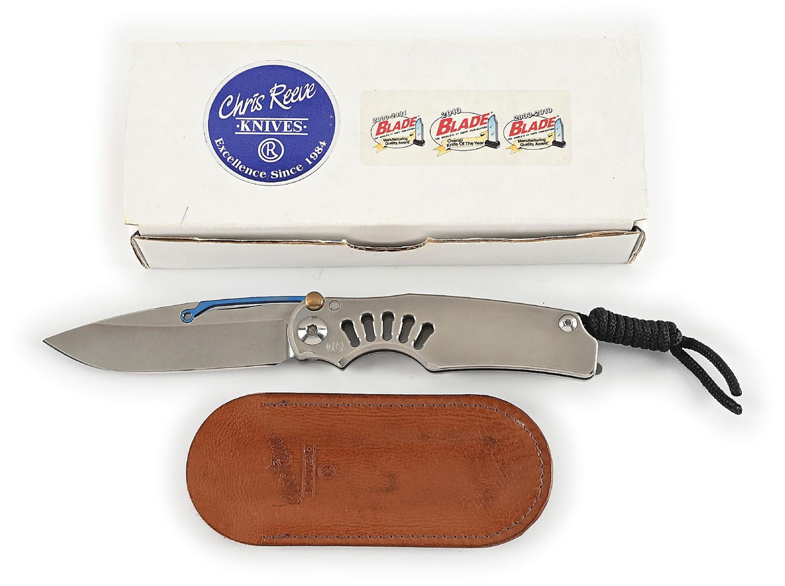 BOXED CHRIS REEVE TI-LOCK.: Features a drop point S35VN blade with anodized titanium ti-lock. Titanium frame is marked near the pivot screw on obverse with the “CR” logo on the obverse and "IDAHO MADE" on the reverse