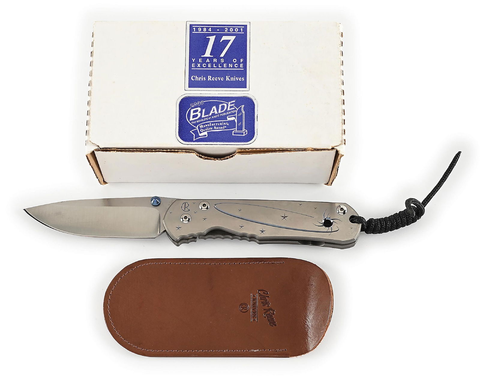 BOXED CHRIS REEVE SOLAR WIND LARGE SEBENZA.: Features a BG42 blade with anodized titanium thumb stud and knurled thumb rest. Titanium frame is marked near the pivot screw on obverse with the “CR” logo. The frame features a titanium b
