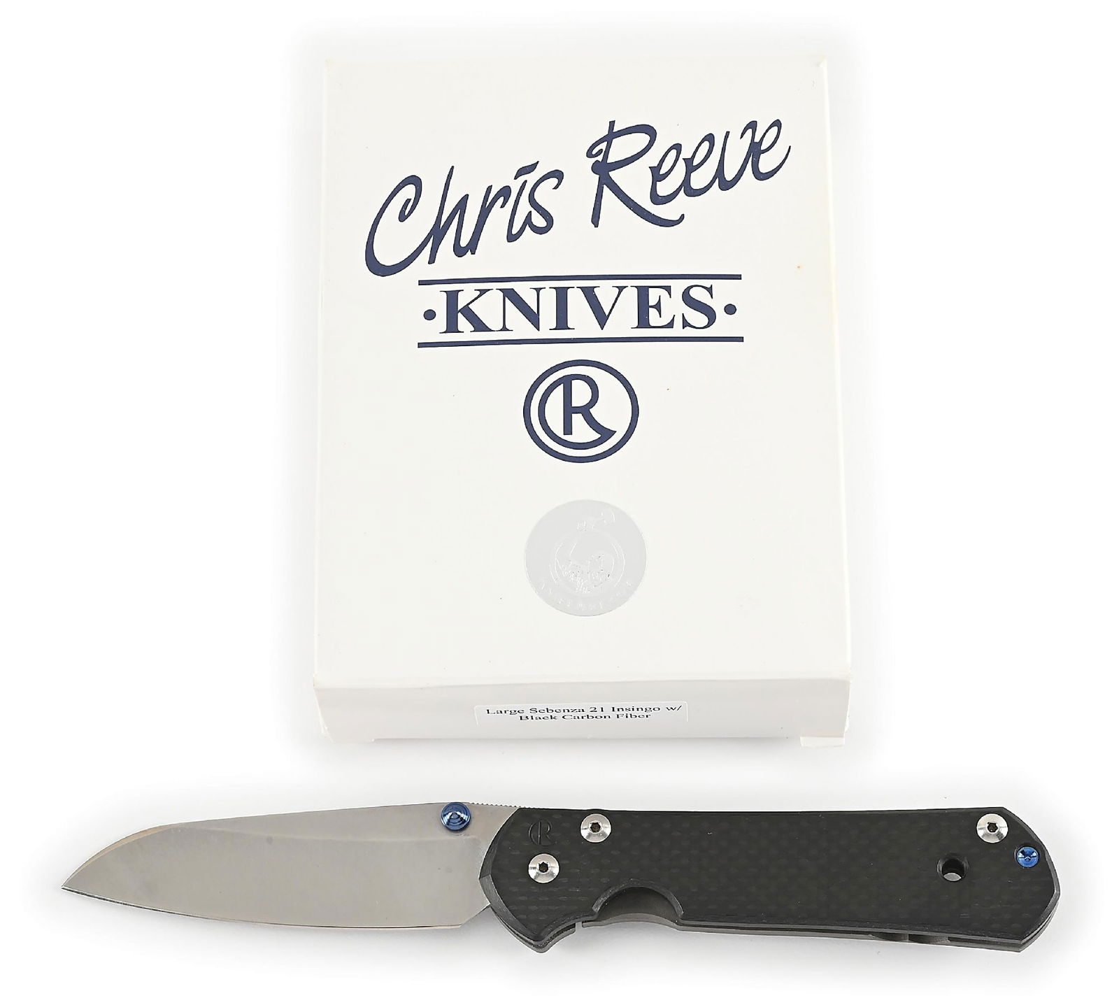 BOXED CHRIS REEVE LARGE SEBENZA 21 INSINGO.: Features a S35VN insingo blade with anodized titanium thumb stud and knurled thumb rest. Titanium frame is marked near the pivot screw on obverse with the “CR” logo and "IDAHO MADE" on