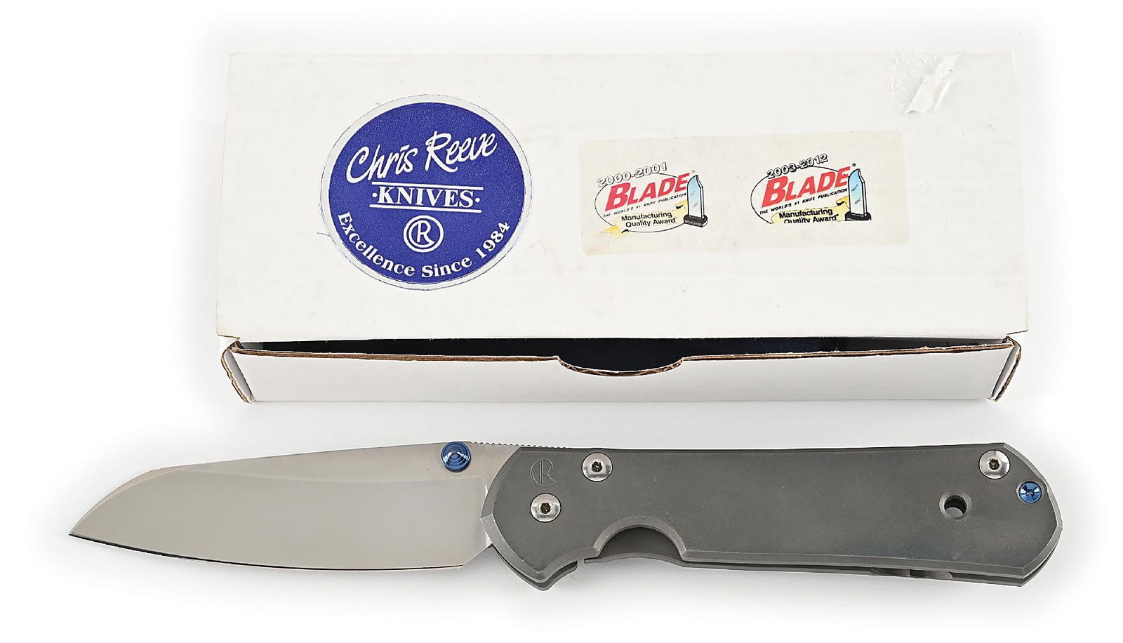 CHRIS REEVE LARGE SEBENZA 21 INSINGO.: Features a S35VN blade with anodized titanium thumb stud and knurled thumb rest. Titanium frame is marked near the pivot screw on obverse with the “CR” logo and “IDAHO MADE”