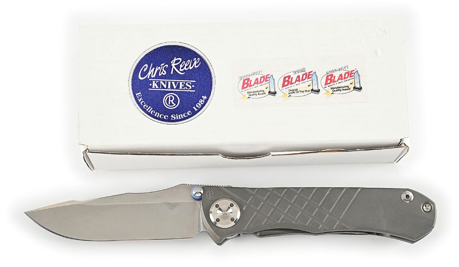BOXED CHRIS REEVE UMNUMZAAN.: Features a stone washed S35VN clip point blade with dual thumb studs and knurled thumb rest. Bead blasted titanium frame is marked near the pivot screw on obverse with the “CR” logo and