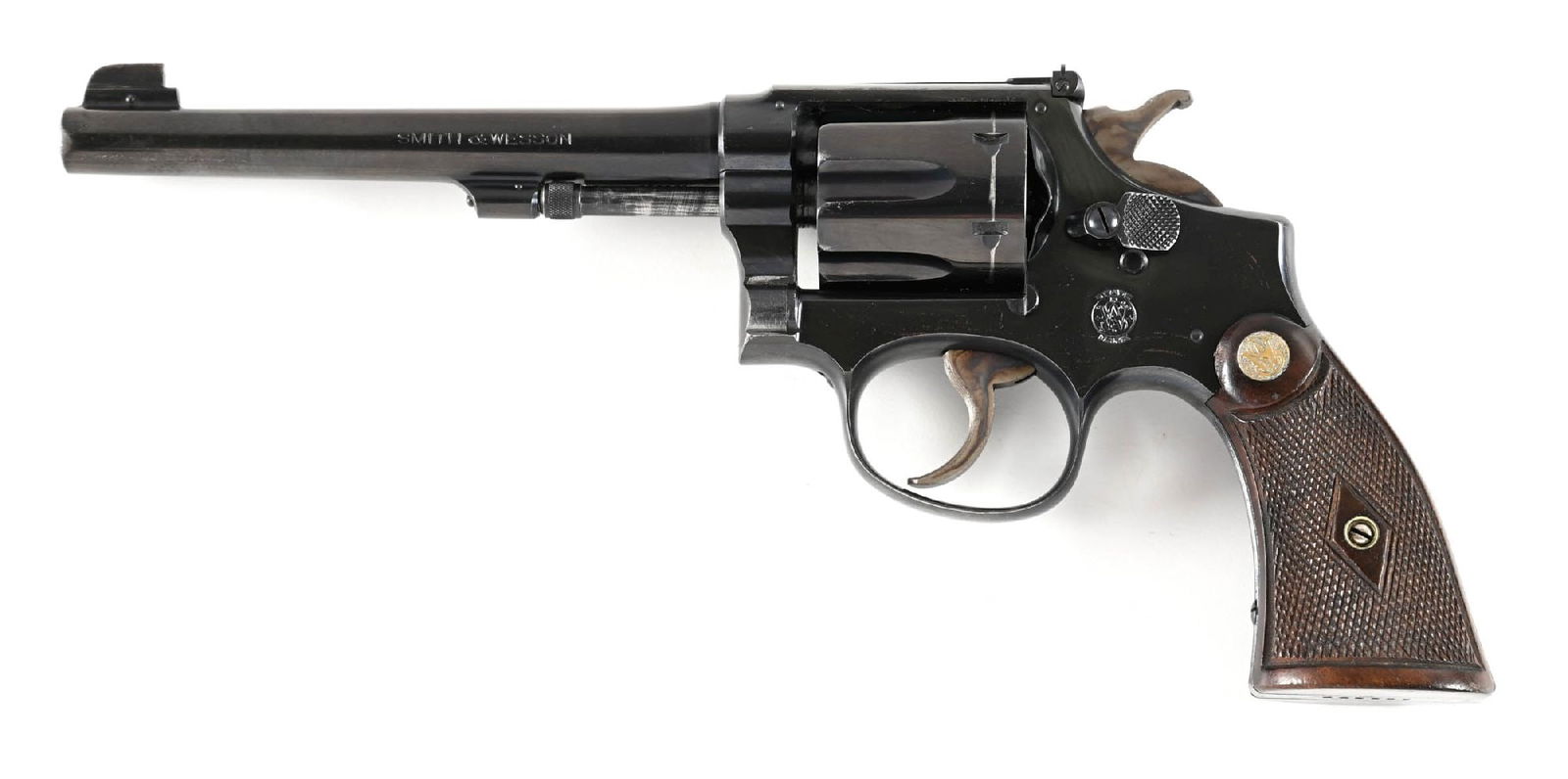 (C) PRE-WAR SMITH & WESSON 1ST MODEL K22 OUTDOORSMAN DOUBLE ACTION REVOLVER.: Built on the square butt 5-scrtew K frame with pinned barrel, recessed chambers, pre-War single diamond checkered walnut grips with silver medallions, round frame, pinned blade on base front sight, ad