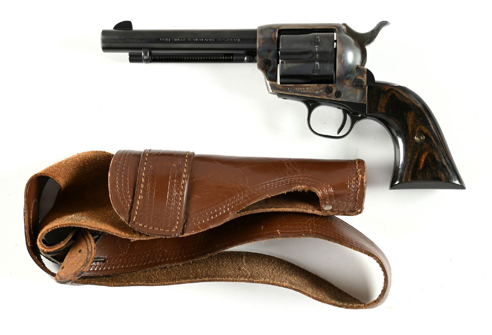 (C) SECOND GENERATION COLT SINGLE ACTION ARMY REVOLVER (1958).: Dates to 1958, the first reintroduction of the .38 Special. This is a standard revolver with custom wood grips. Comes with a leather shoulder holster. CONDITION: Excellent. Solid 98% but does show min