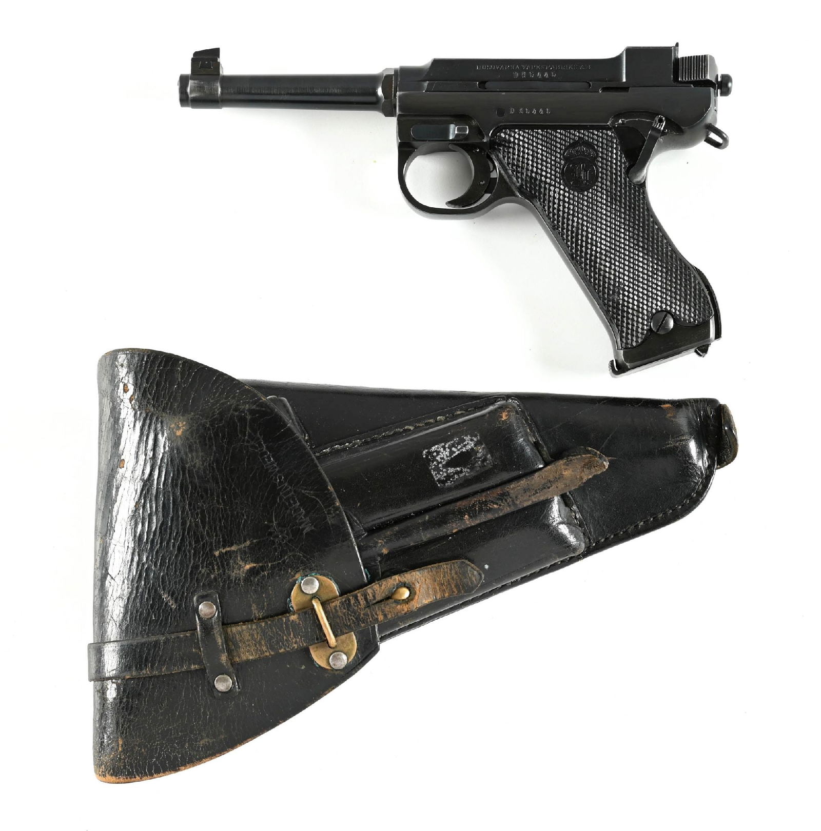 (C) HUSQVARNA M40 SEMI-AUTOMATIC PISTOL.: D prefix serial number indicating it was one of the Police contract pistols delivered in 1947, HV control marks for the Dane police. Comes with original holster which contains wiping rod and combinati