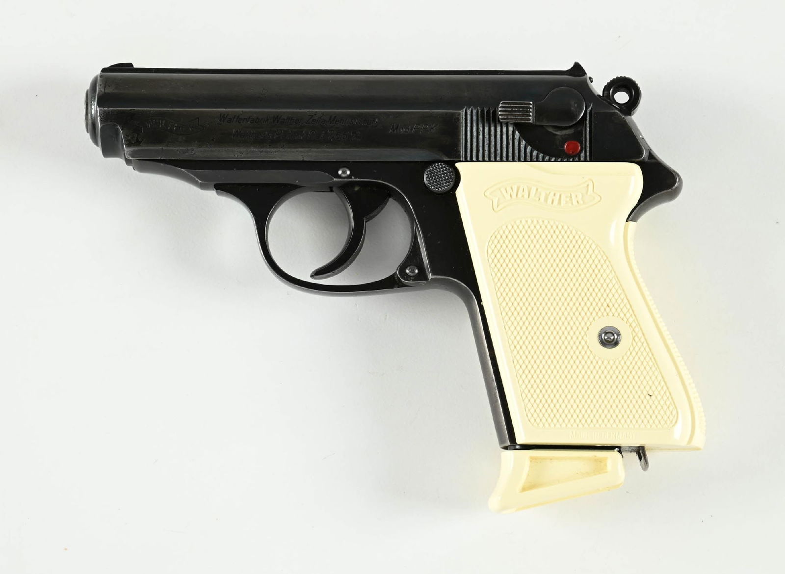 (M) WALTHER PPK SEMI-AUTOMATIC PISTOL.: Manufactured in 1935. Features the early style 90-degree safety, loaded chamber indicator pin, and a high polished blue finish. "(Crown) / N" proofs visible on the barrel and the slide. CONDITION: The