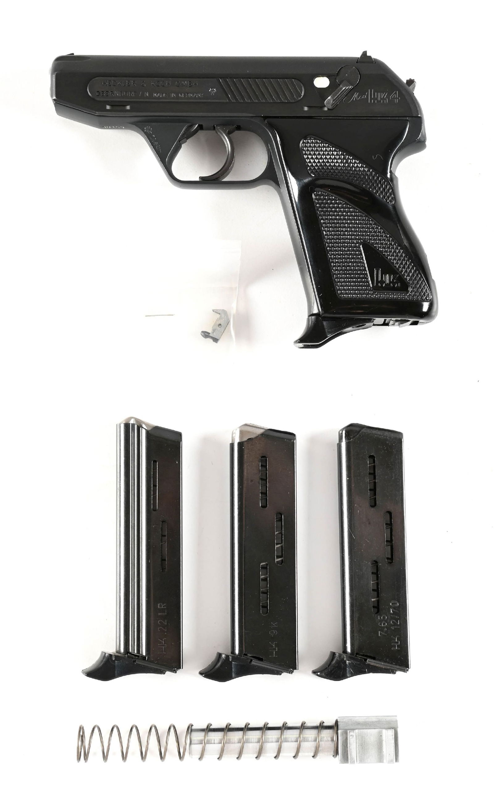 (M) HECKLER & KOCH MODEL 4 SEMI-AUTOMATIC PISTOL WITH CONVERSION BARREL AND MAGAZINES.: Manufactured in 1980. Matte finished with brushed blue slide sides. Fixed front sight and drift adjustable square notch reach. Fitted with wraparound checkered plastic grips. Currently configured in .