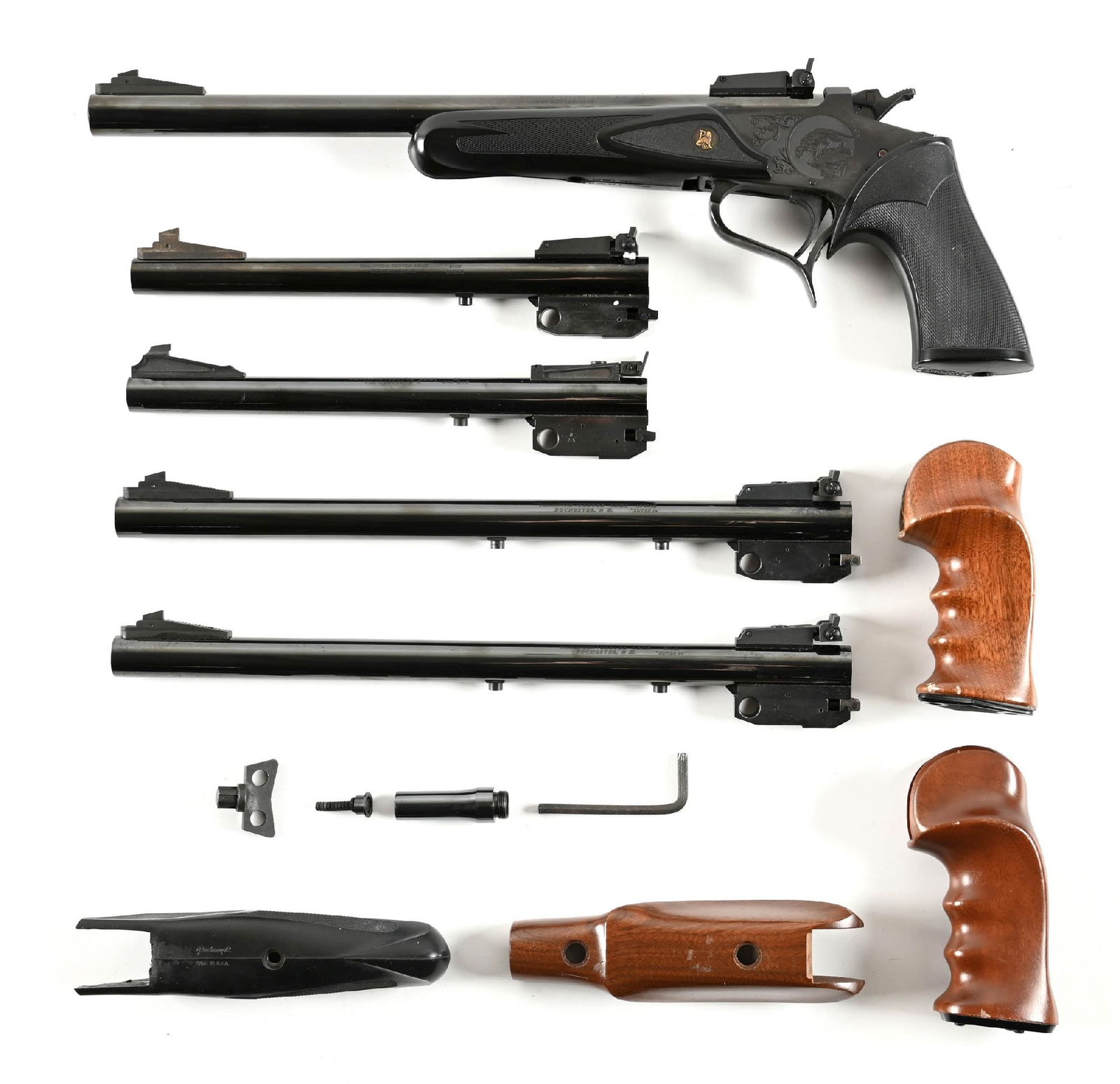 (M) THOMPSON CENTER CONTENDER SINGLE SHOT PISTOL WITH FIVE BARRELS.: The complete pistol features the Pachmayr grip and forearm. Barrel is 14" in 7mm TCU caliber and comes with target rear and front sights. Metal is blue as are all four of the extra barrels, all with s