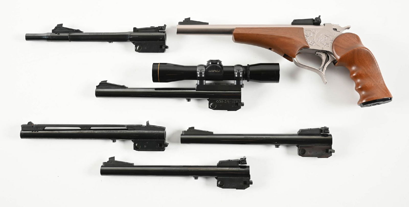 (M) THOMPSON CENTER CONTENDER SINGLE SHOT PISTOL WITH FIVE EXTRA BARRELS.: The boxed complete Contender is brushed stainless with the wood grip and forearm. The barrel is caliber 7mm TCU, 10", with the adjustable rear sight. A. First extra barrel is blue, 10", front sight wi