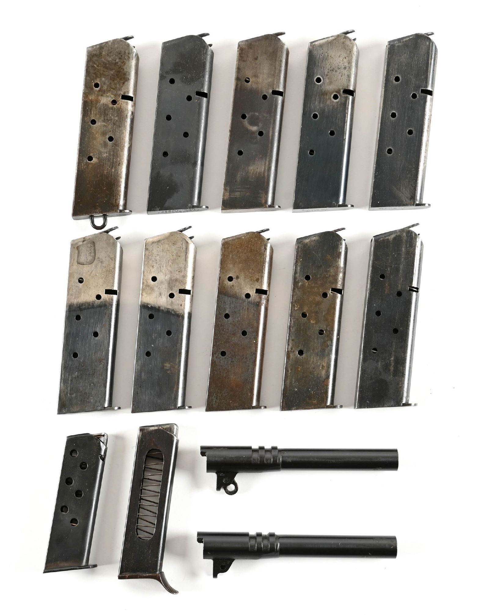 LOT OF 10 COLT 1911 : MAGAZINES AND 2 1911 BARRELS.: Lot consists of (A) 3 Colt 1911 pre-war two toned tempered mags (B) Pre-1915 lanyard loop mag, (C) Post Vietnam stamped mag, (D) Three full blue commercial mags stamped "Colt .45 Auto" (E) Two plain