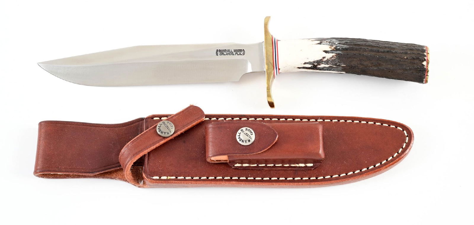 RANDALL MODEL 1-7 ALL PURPOSE FIGHTER.: Clip point blade marked "RANDALL MADE / ORLANDO, FL" between Randall's signature scimitars. Carbon steel construction. Blade is bright with great crossgraining. Brass crossguard with red, white, and b