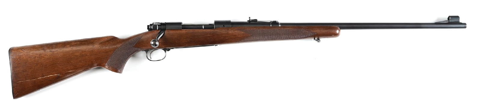 (C) PRE-64 WINCHESTER MODEL 70 BOLT ACTION RIFLE IN .303 BRITISH.: Manufactured in 1946. Blue finished with ramped front sight and elevation adjustable rear sporting sight. 2-line barrel address with added ".303 BRIT" caliber marking; marking is not factory and a cha