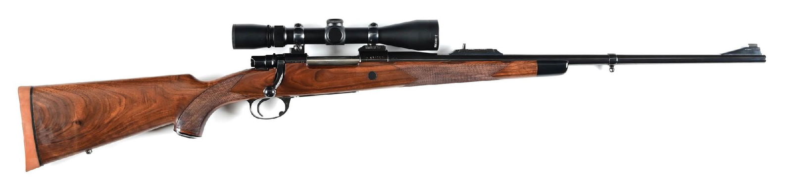 (M) INTERARMS MARK X BOLT ACTION RIFLE IN 7MM REMINGTON MAGNUM.: This rifle is marked "Manchester, England" and is based on the Mauser action. Features the high polish blue finish, a bead on ramp base front sight, a 3-leaf express style rear sight, the oil finished