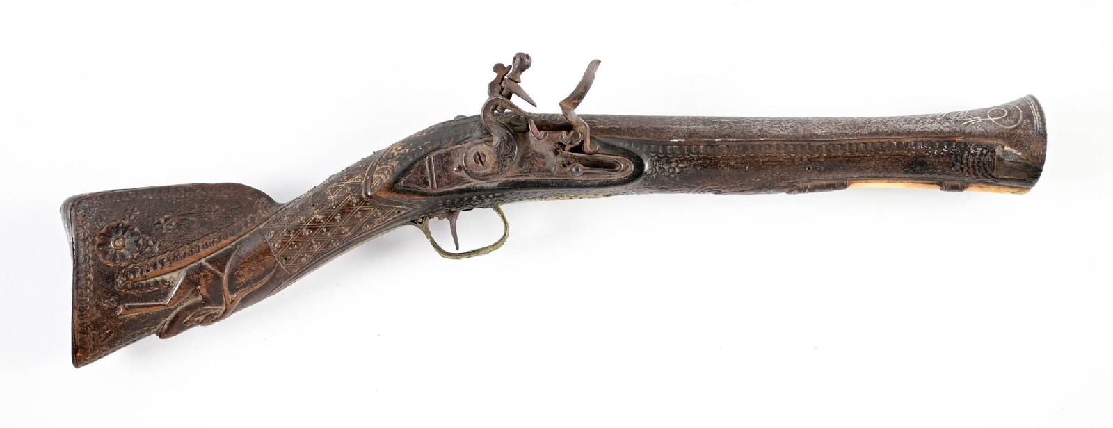 (A) MIDDLE EASTERN FLINTLOCK DAG.: Of classic form, with silver inlay throughout the barrel in the form of geometrics and florals with a faux Damascus pattern. Repousse brass furniture, and decorative fixed "ramrod". Wrist with basketw