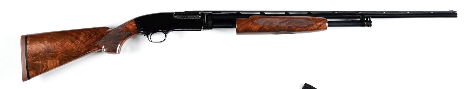 (C) WINCHESTER MODEL 42 SLIDE ACTION .410 SHOTGUN.: Simmons vent rib, deluxe varnished and checkered walnut stocks with pistol grip and Pachmayr recoil pad. Manufactured 1950. CONDITION: Very fine with bright bore. Mechanically excellent. Refinished me
