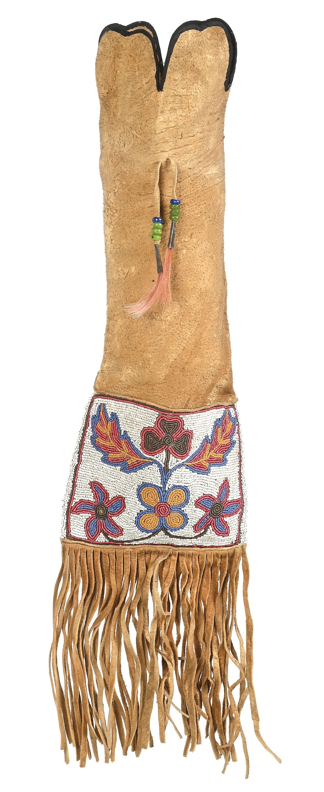 CREE BEADED PIPE BAG: A traditionally styled Cree tobacco bag with floral beaded panels in yellow, red, blue, and gray on a white field. Tin cone drops and bottom fringe. 6" fringe and a 17" length bag, Native tanned hide.