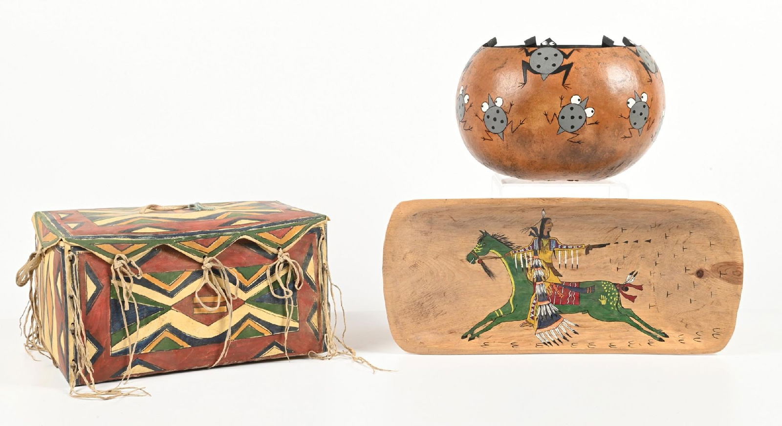 LOT OF 3: PARFLECHE BOX, GOURD WITH FROG MOTIF AND TRAY/BOWL: All are contemporary. (A) Parfleche box. (B) Gourd bowl with frogs. (C) Wooden tray with ledger drawing. Dimensions: Largest: 15 - 1/2" x 10 - 3/8" x 8 - 1/2".