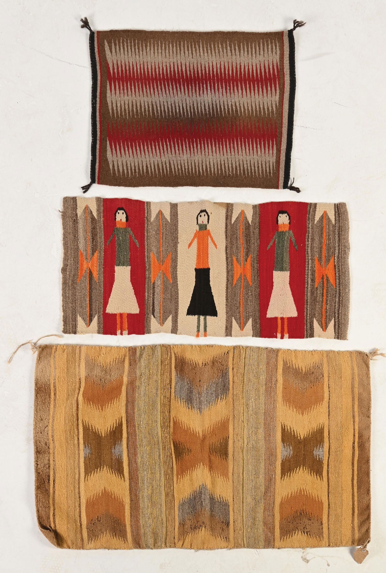 LOT OF 3: NAVAJO (DINÉ) WEAVINGS: (A) Wide Ruins. Warp showing, some holes, side selvedge damage, corners curling, one side showing extensive moth damage. 45-1/2" x 25". (B) Navajo Rug. Good condition. 38" x 17". (C) Navajo Gallup