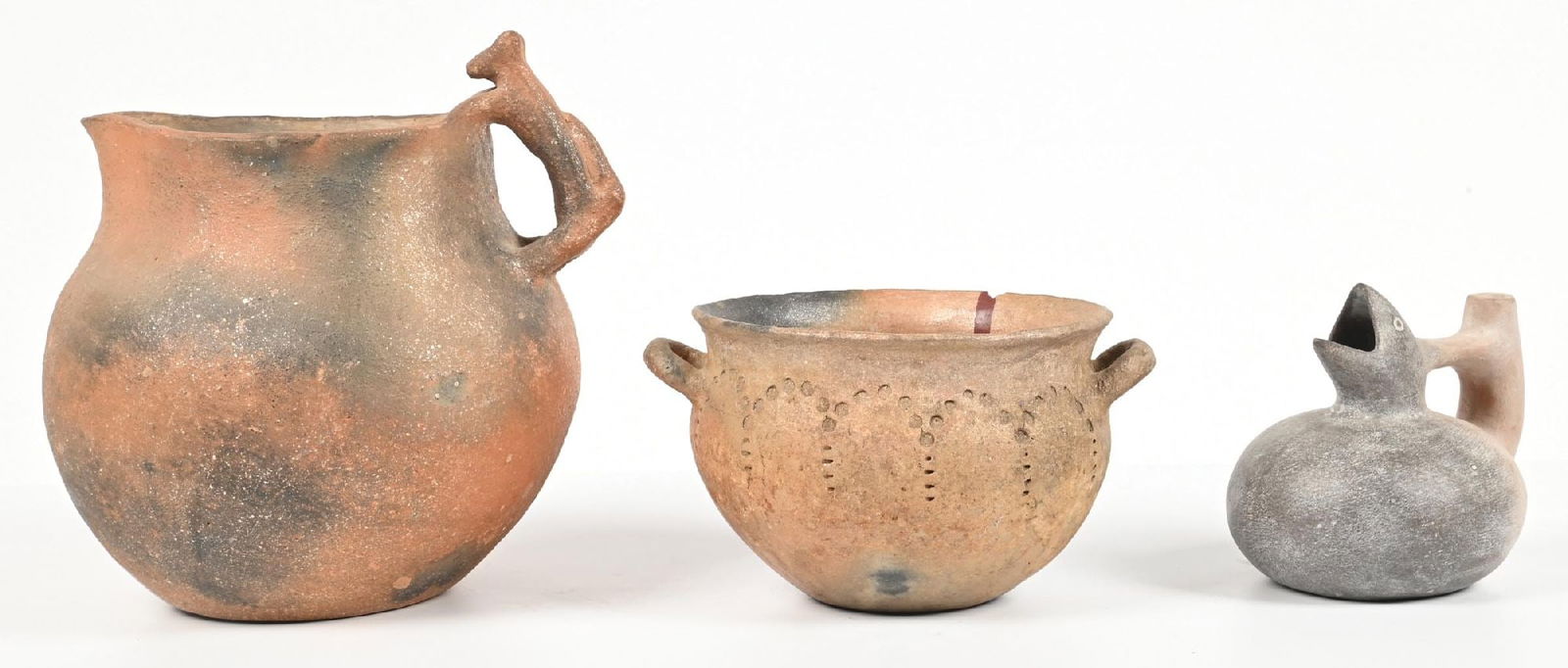 LOT OF 3: SOUTHWESTERN POTTERY ITEMS: (A) Circa early 20th century. Taos Pueblo Pitcher with animal handle. Pitting throughout. (B) Circa early 20th century. Taos Pueblo Bowl. Rim chip. (C) Contemporary replica of Pre-Columbian pottery.