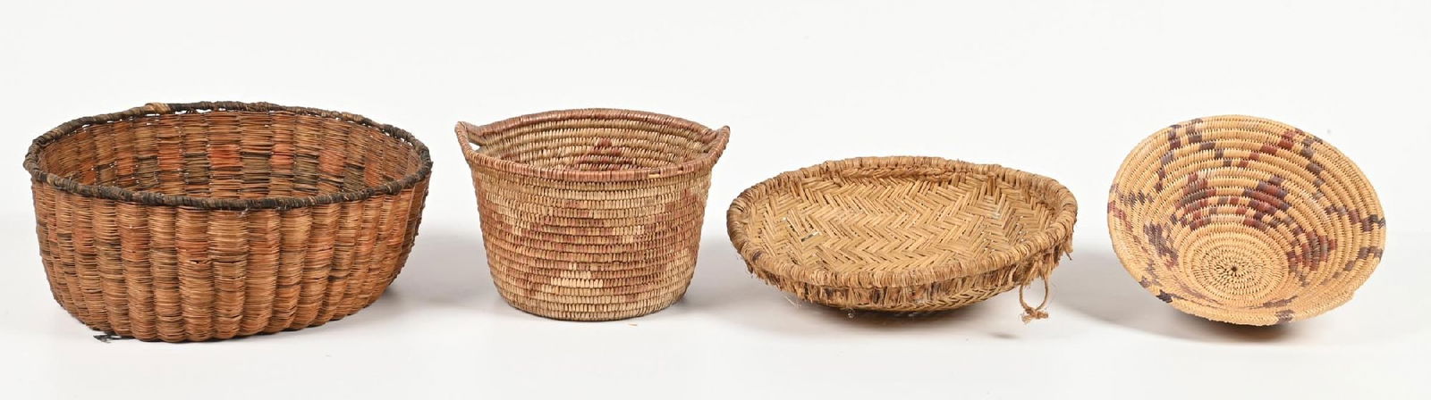 LOT OF 4: NATIVE AMERICAN BASKETS: (A) Hopi Wicker. (B) Jicarilla Apache.(C) Mescalero Apache. (D) Hopi Piki Tray. Provenance: Estate of N. Harman. Dimensions: Largest: 12" Dia. x 6 - 1/4".