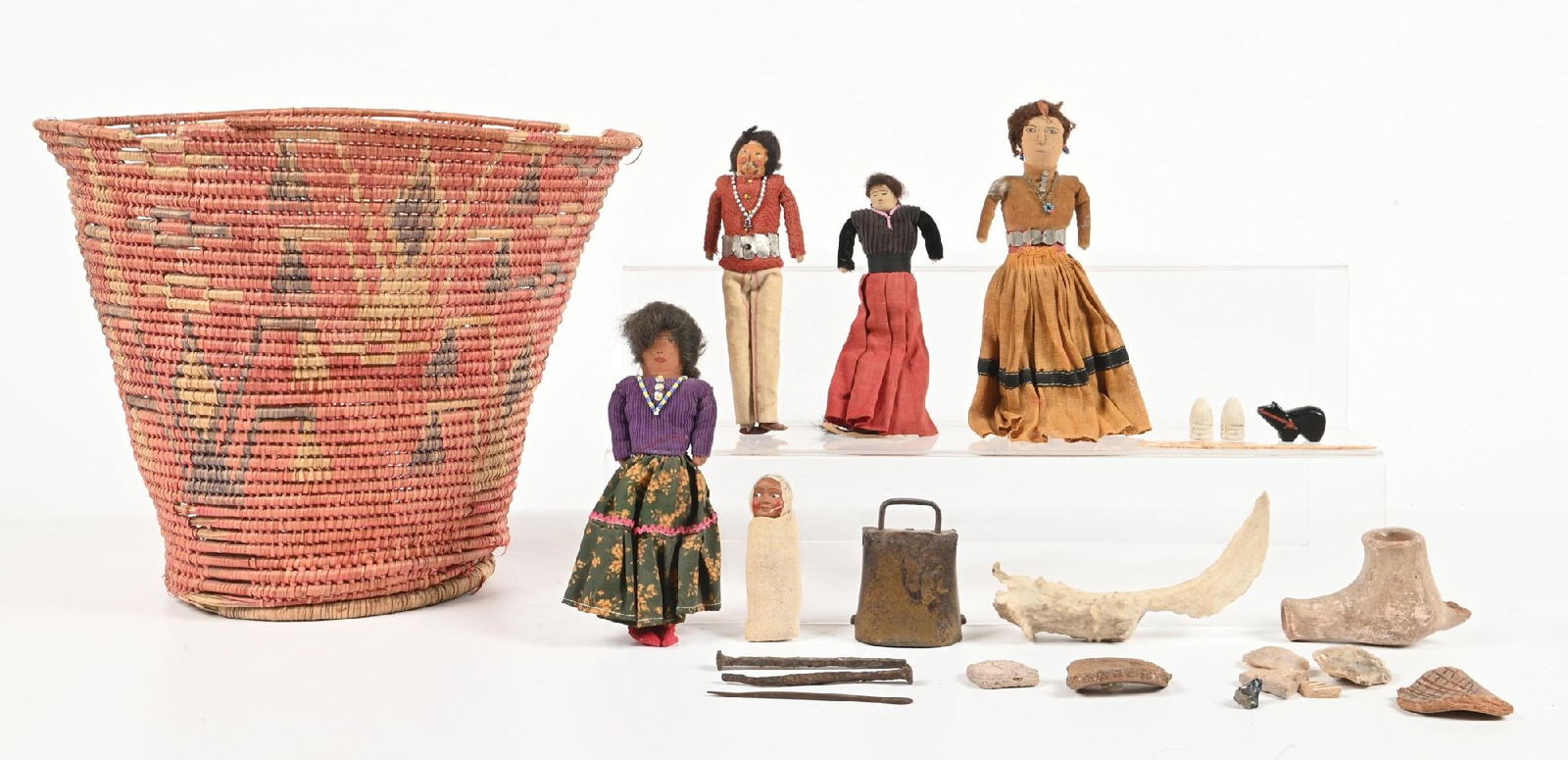 MISCELLANEOUS SOUTHWEST ITEMS: Includes Mexican basket with extensive damage, five Navajo dolls, cowbell, two Civil War bullets, pottery and flint shards, copper needles, bone tool, antler knife, pottery pipe bowl with broken tip,