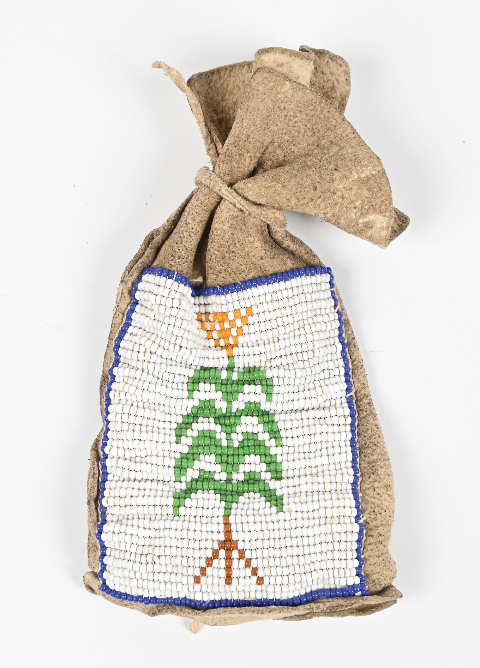 PLATEAU BEADED POUCH: Contains a polished stone with pollen dust on it. Provenance: Estate of N. Harman. Dimensions: 3 - 1/4" x 6".