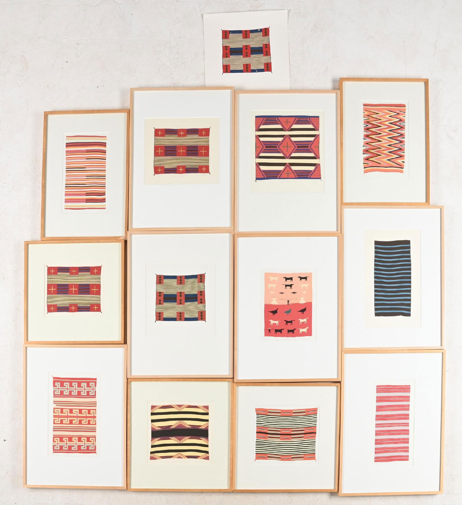 LOT OF 13: FRAMED SCREENPRINTS OF VARIOUS NAVAJO CLASSIC BLANKETS BY MICHELE MENOTTI: 12 are in birch frames, 1 loose. Largest: 13-1/4" x 8-1/4", framed 25-1/4" x 19-3/4" x 1-1/2". Smallest: 7-3/4" x 10", framed 19" x 18" x 1-1/4". 1 of the framed is of a Rio Grande blanket, not a