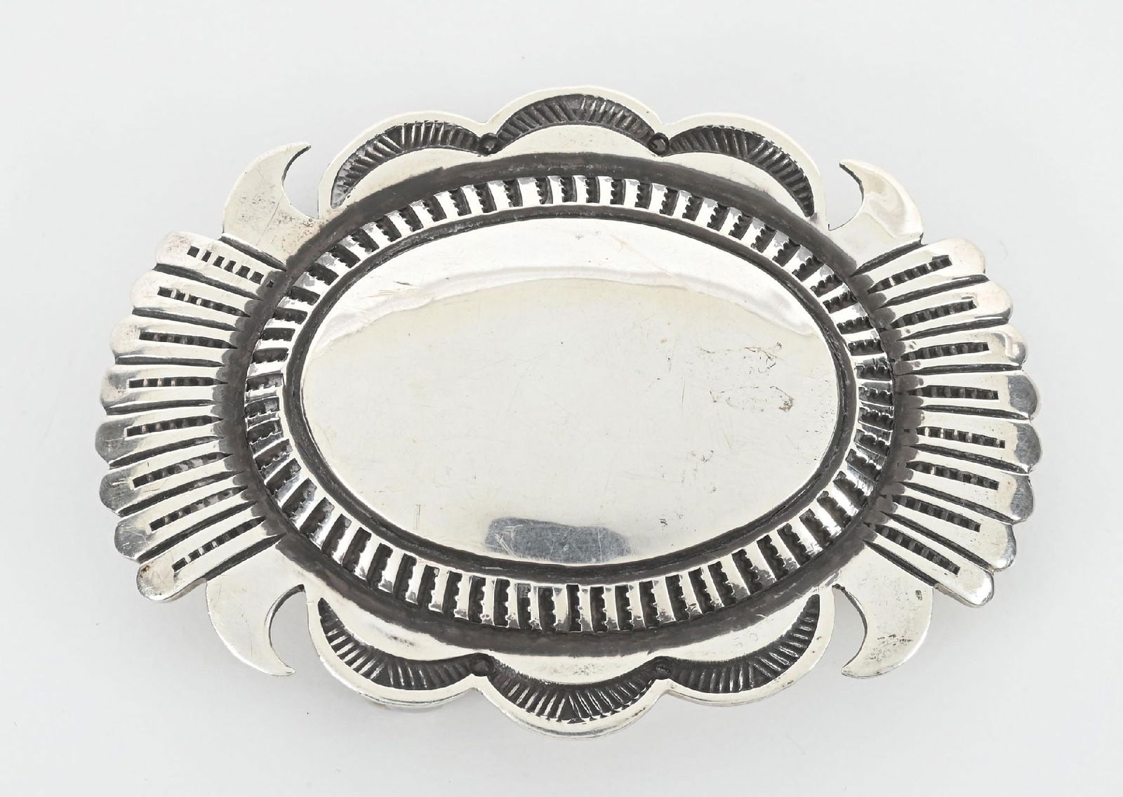 E. NELSON STERLING SILVER BELT BUCKLE: Native artisan signed Southwest style sterling silver buckle. Dimensions: 2 - 1/2" x 1 - 3/4".