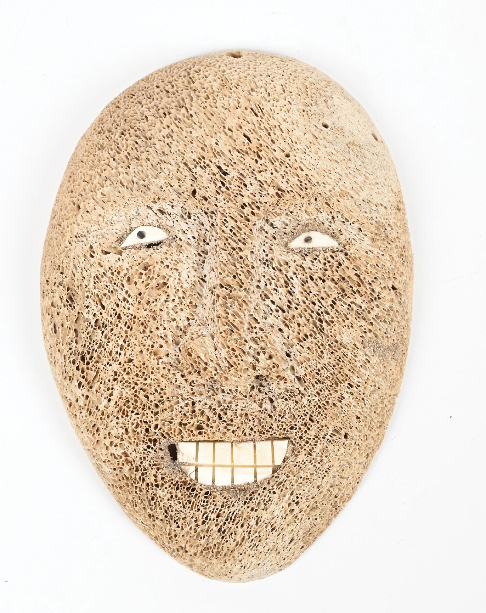 ESKIMO WHALE BONE CARVING OF A FACE: Contemporary. With inlaid eyes and teeth. Dimensions: 6 - 1/2" x 4 - 1/2".