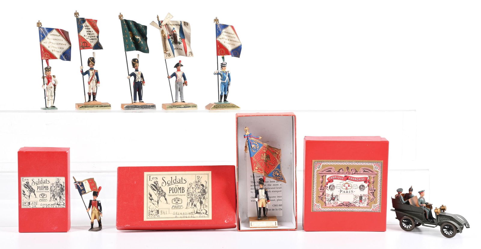LOT OF 4: GUY RENAUD & MIGNOT TOY SOLDIER SETS: (A) Mignot Grenadier Marching Flag Bearer. (B) Mignot Grenadier Cheval Standard Bearer at attention. (C) Mignot Imperial German Army WWI Period Automobile with 3 figures. (D) Guy Renaud Standard Beare