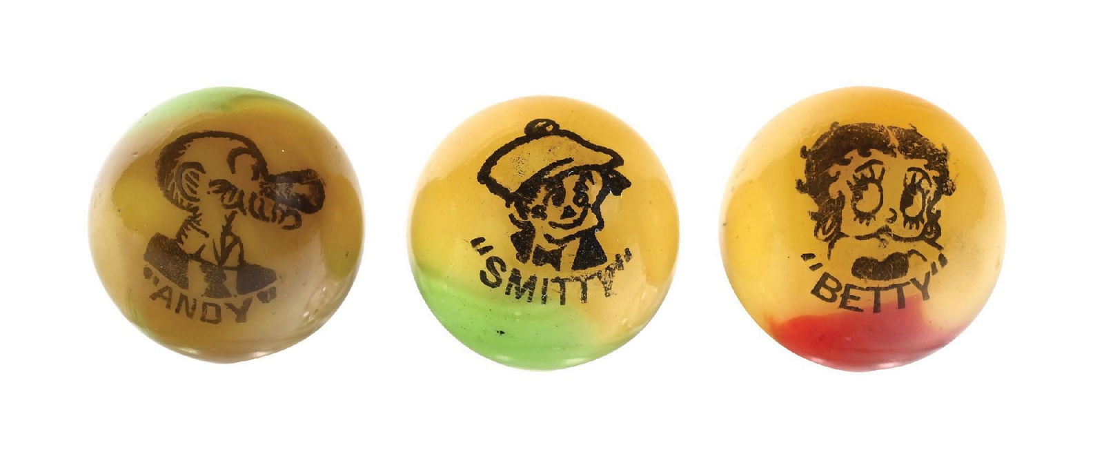 LOT OF 3: PELTIER COMIC MARBLES: Collection of three Peltier marbles which includes a yellow base with green patch smitty; yellow base betty with red patch; mustard yellow base and andy with a lime green patch. All strikes are bold.