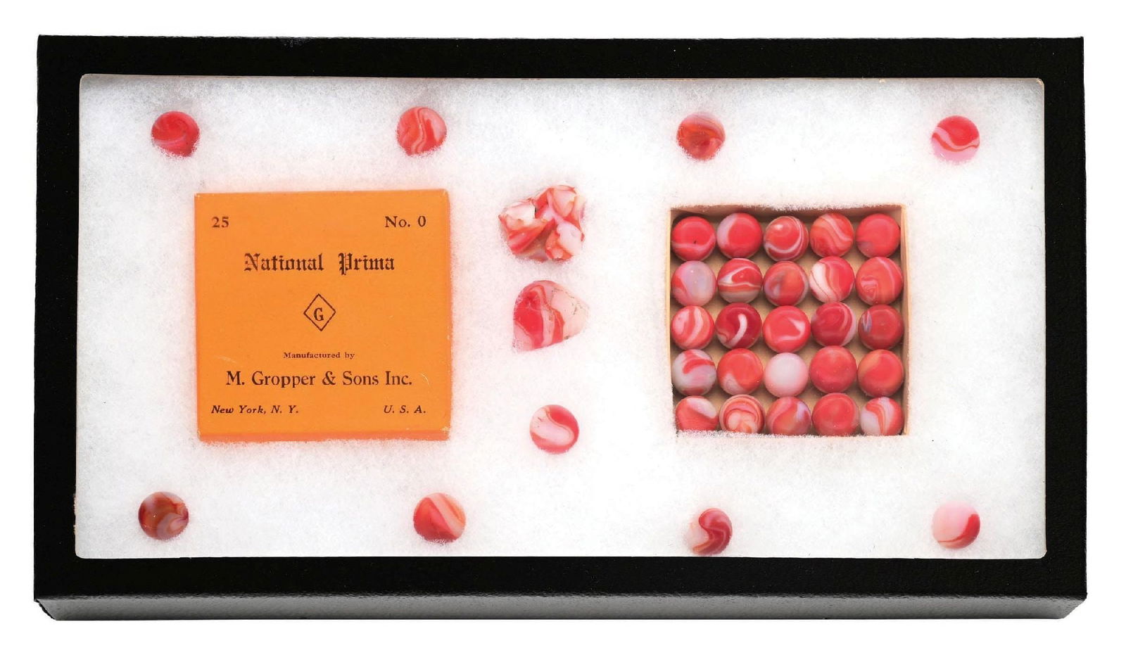 25-COUNT NATIONAL PRIMA BOX SET NO. 0 WITH EXTRAS IN SHADOW BOX: 5/8" diam. Rare set with 25 marbles, including extra marble and cullet. Marbles: (9.5 Average). Box: (Excellent). Condition: Dimensions: Shadow Box: 14 - 1/2" x 8" x 1 - 3/4".
