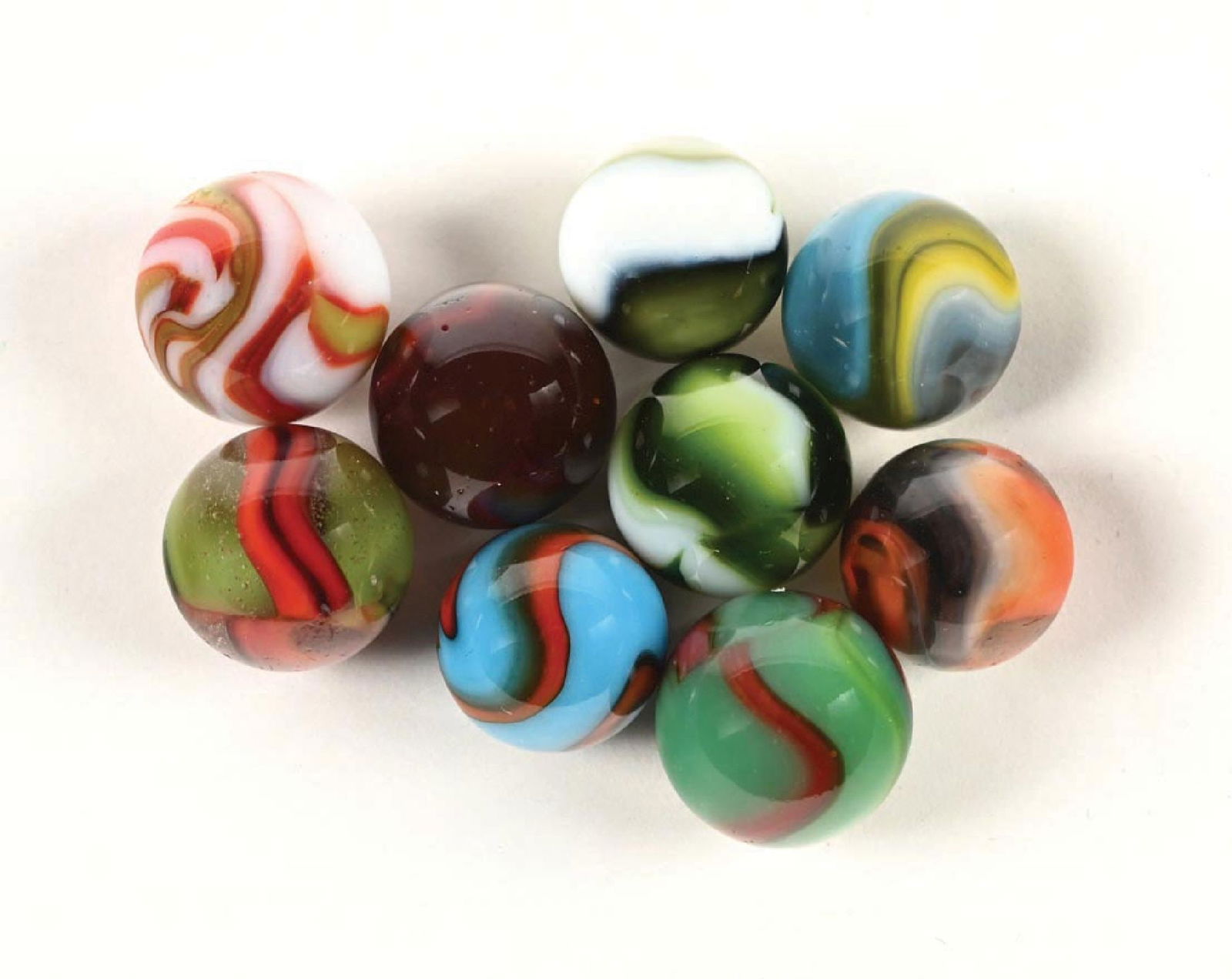 LOT OF 9: VARIOUS PELTIER MARBLES: Collection of 9 Peltier marbles which includes 2 Pine Needle, one Miller Christmas tree, one Clear Dragon, one NLR Clear (with blue, white, yellow, and ox blood), one Spiderman, one Spider Dragon,