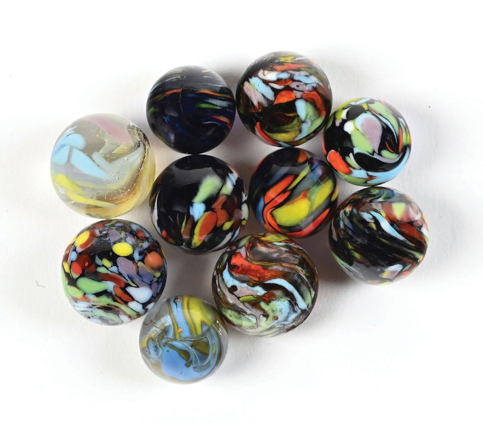 LOT OF 10: CONTEMPORARY CHRISTENSEN MARBLES: Lot includes 8 contemporary guineas in various colors and two contemporary cyclones. Condition: (9.5). Dimensions: Largest: 3/4" Dia.