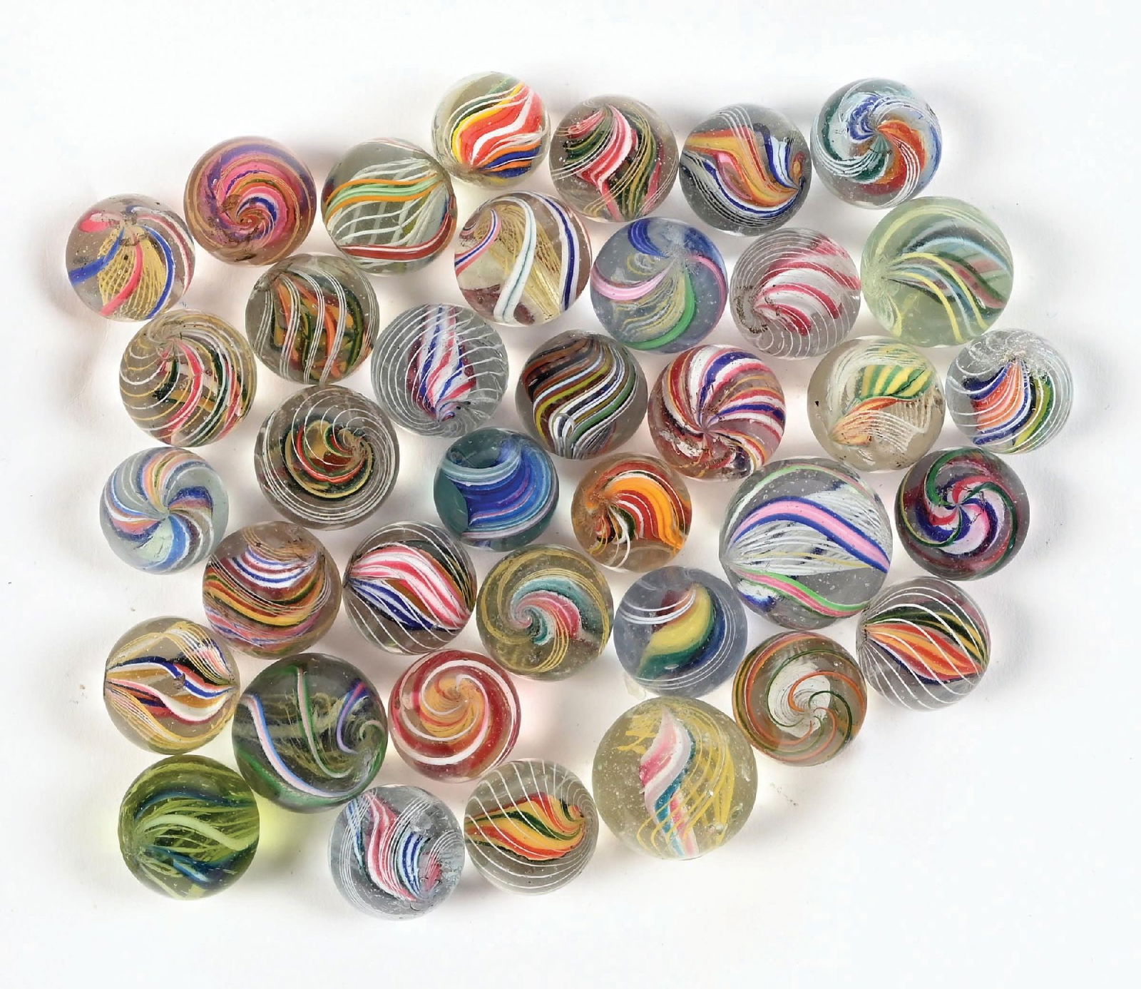 LOT OF APPROXIMATELY 37 MULTICOLOR HANDMADE SWIRL MARBLES: 3/4" - 63/64" diam. Includes two ribbon core marbles. Condition: (9.0). Dimensions: Largest: 1" Dia.
