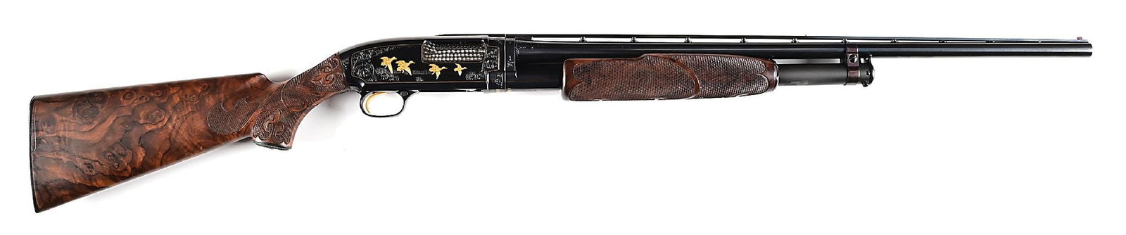 (C) JOHN KUSMIT ENGRAVED WINCHESTER MODEL 12 PIGEON GRADE SLIDE ACTION 20 GAUGE SHOTGUN.: Winchester Model 12 with post pattern vent rib, Modified choke, and 2 3/4" chamber. Elegantly game scene engraved with gold inlays of hunting dogs and flushing grouse, opposite side embellished with w