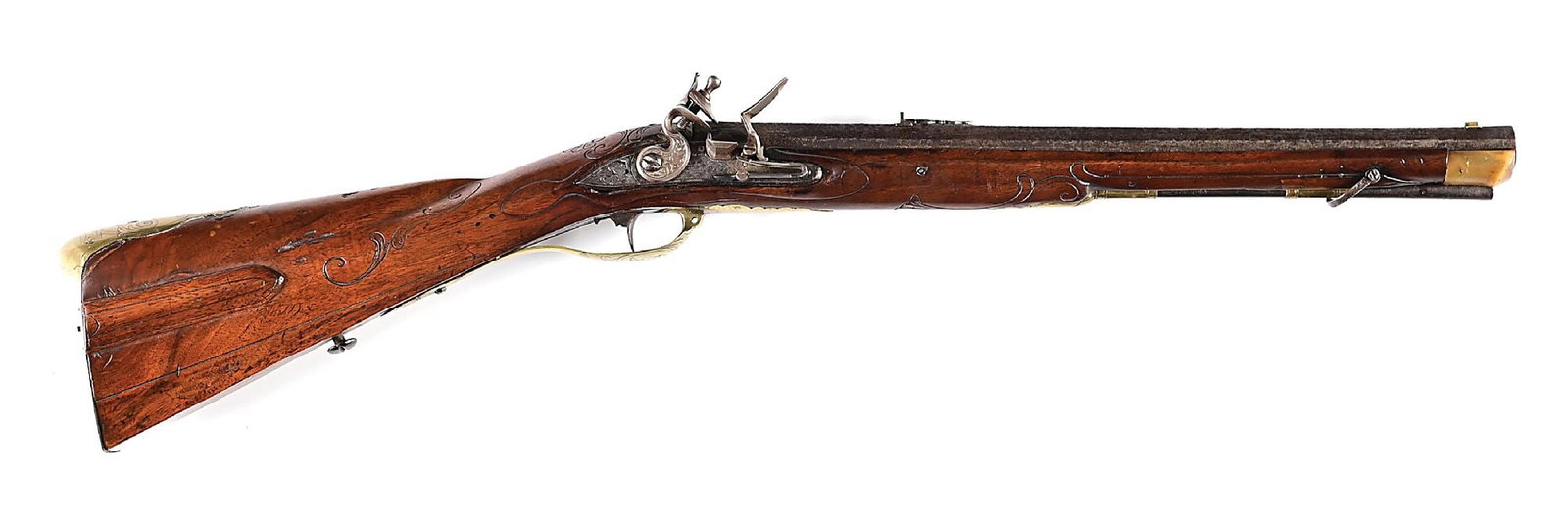 (A) INCISE CARVED FLINTLOCK JAEGER CARBINE.: Rifled octagon barrel with swamped muzzle and decorative rear sight. Lockplate engraved worth game scenes. The brass furniture is engraved. Walnut stock with sliding wood patchbox and incise-carved sc
