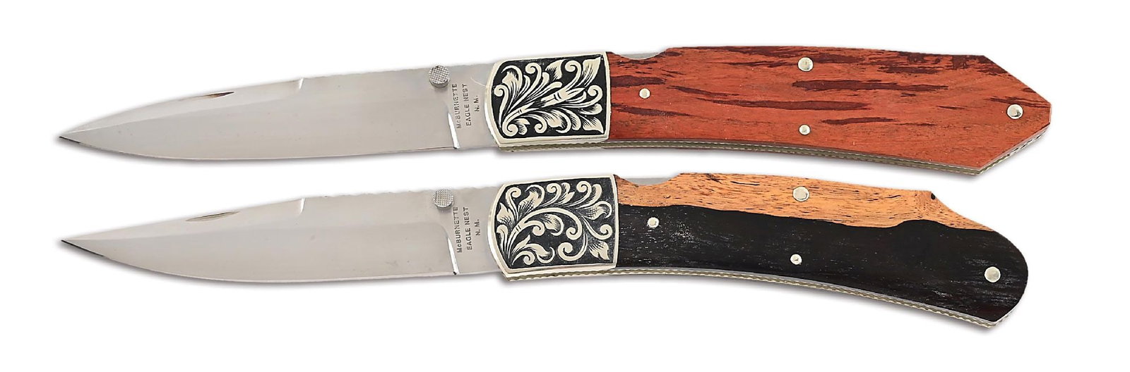 LOT OF 2: HARVEY MCBURNETTE ENGRAVED LOCKBACK FOLDERS.: Lot consists of: (A) Satin finished drop point blade with nail nick assist and a checkered thumb stud. Blade is marked "McBURNETTE / EAGLE NEST / N.M." on obverse ricasso. Spine is fileworked as well